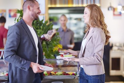 Biznesmen i bizneswoman o owocach z baru sałatkowego