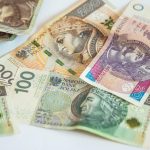 Detailed view of Polish currency banknotes, featuring multiple denominations and designs.