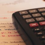 a calculator sitting on top of a piece of paper