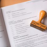 brown wooden hand tool on white printer paper