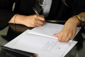 a person writing on a piece of paper