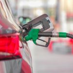 a gas pump is connected to a car at a gas station