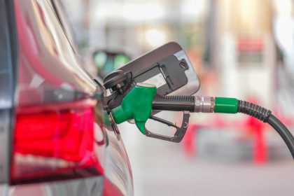 a gas pump is connected to a car at a gas station