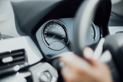 person holding steering wheel