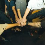 a group of people holding hands in a circle