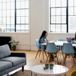 two women sitting in front of white table