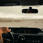 person driving car during daytime