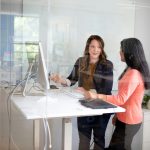 2 women sitting at table