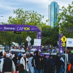 Runners and spectators gather at the cap10k race.