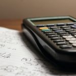 a calculator sitting on top of a piece of paper